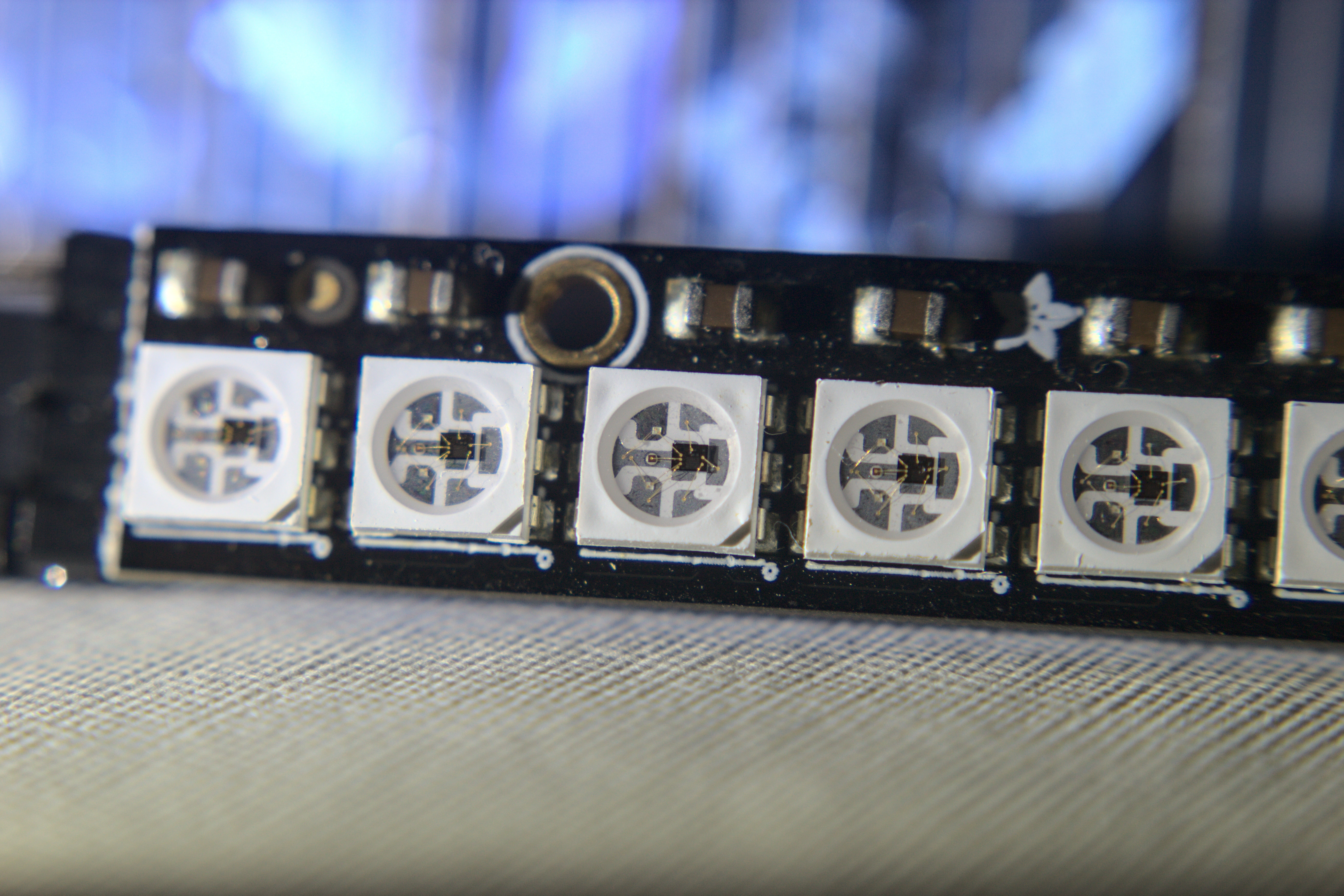 Close-up photograph of WS2812 addressable LEDs mounted on an Adafruit NeoPixel Stick