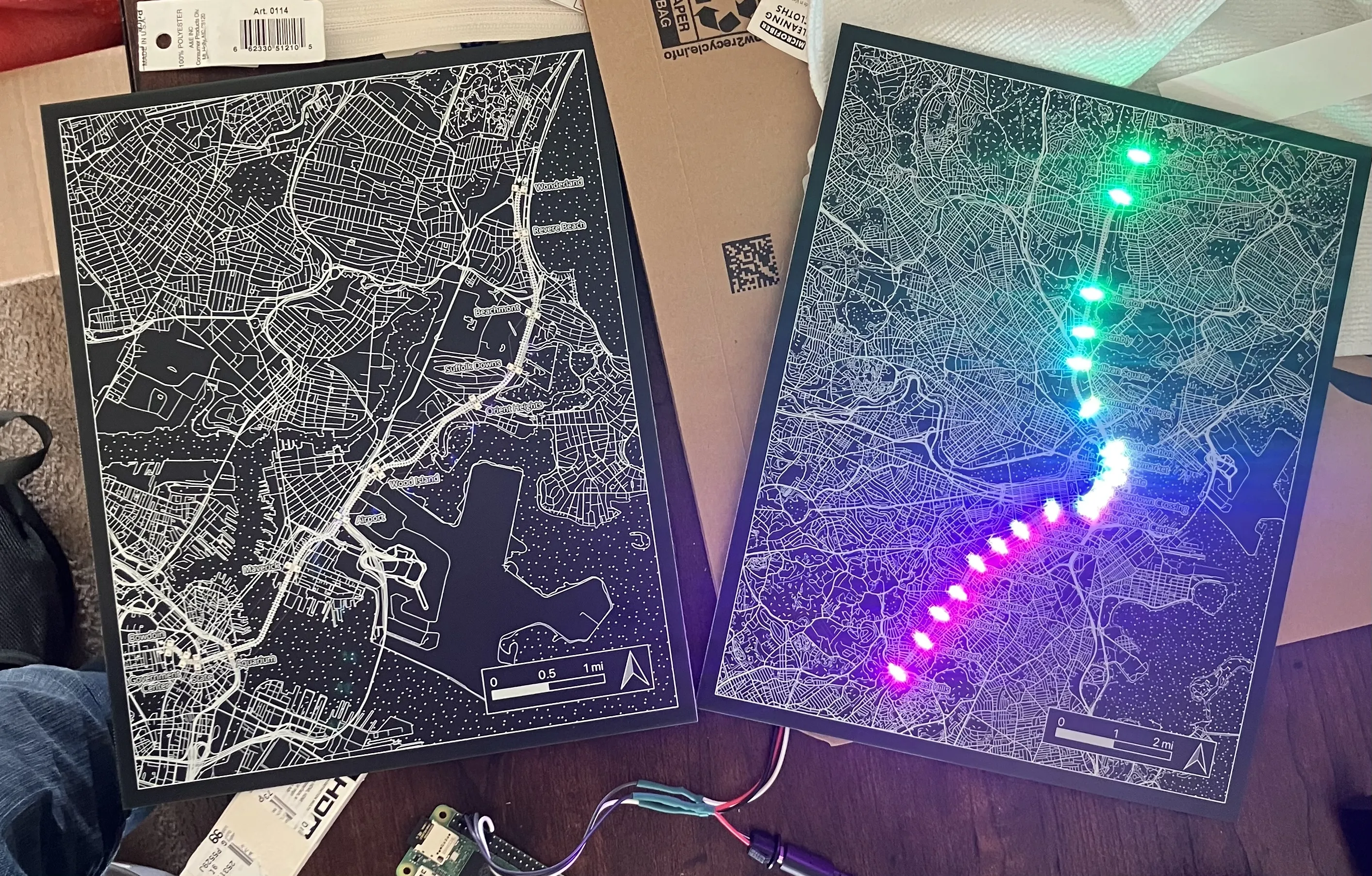 Photo of the Blue and Orange Line PCBs, one lit up in a rainbow